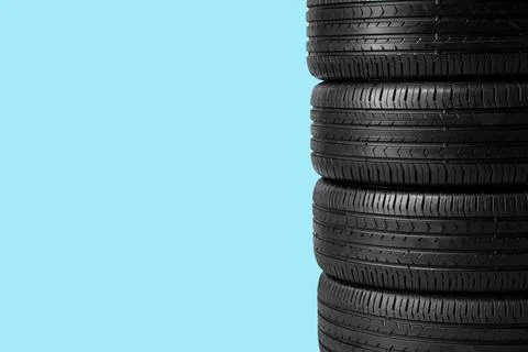 Stack of car tires on blue background Stock Photos