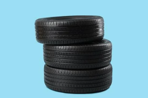 Stack of car tires on blue background Stock Photos