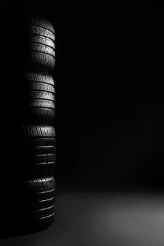 Stack of car tires on dark background Fotos de archivo