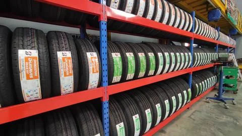 Stack of car tires at modern warehouse Fotos de archivo