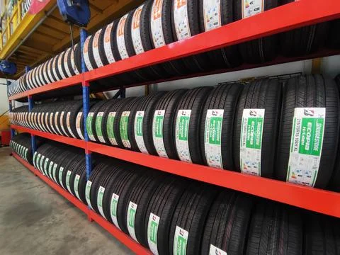 Stack of car tires at modern warehouse Stock Photos