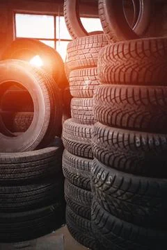 Stack of car wheel tires at modern warehouse Stock Photos