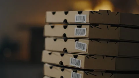 A stack of cardboard boxes with barcodes. Preparing boxes for packaging pizz Stock Footage 263900440