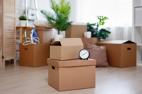 Stack of cardboard boxes with belongings prepared for moving into new house Stockfoto's