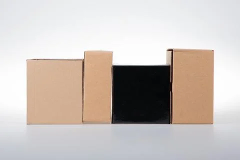 Stack of cardboard boxes black brown box of different sizes on white backgrou Stock Photos