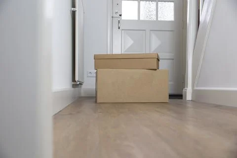 Stack of Cardboard boxes blank in the Hallway of new home on the floor. Moving Stock Photos