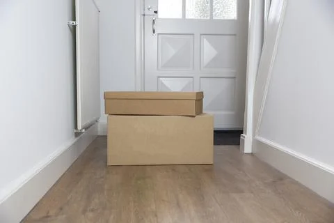 Stack of Cardboard boxes blank in the Hallway of new home on the floor. Moving Stock Photos