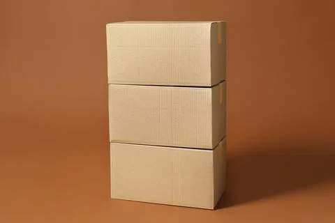 Stack of cardboard boxes on brown background Stockfoto's