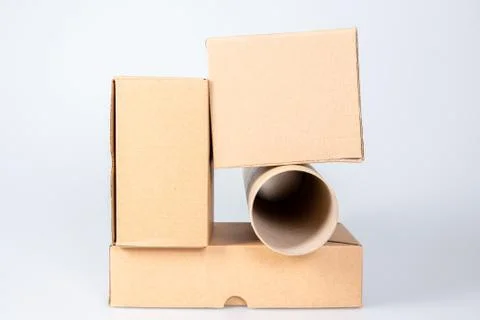 Stack of cardboard boxes with card board tube on white background Foto stock