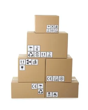 Stack of cardboard boxes with different packaging symbols on white background Stock Photos