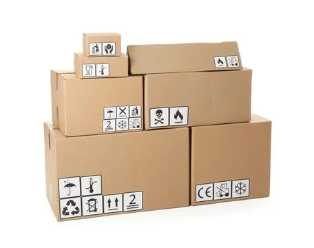 Stack of cardboard boxes with different packaging symbols on white background Stock Photos
