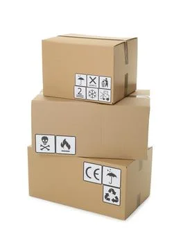 Stack of cardboard boxes with different packaging symbols on white background Stock Photos