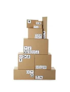 Stack of cardboard boxes with different packaging symbols on white background Stock Photos