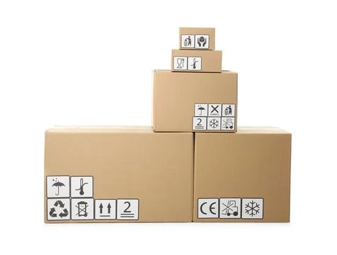 Stack of cardboard boxes with different packaging symbols on white background Stock Photos