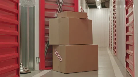 Stack of Cardboard Boxes by Doorway of Self Storage Unit Stock Footage 259826895