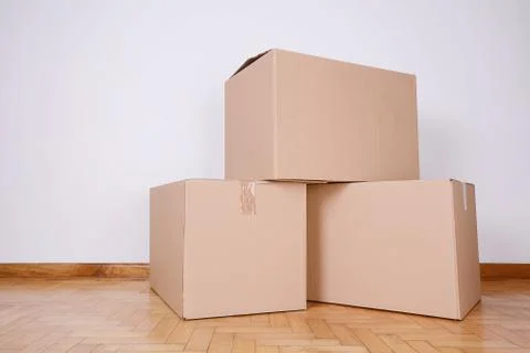 Stack of cardboard boxes in the empty room Stock Photos