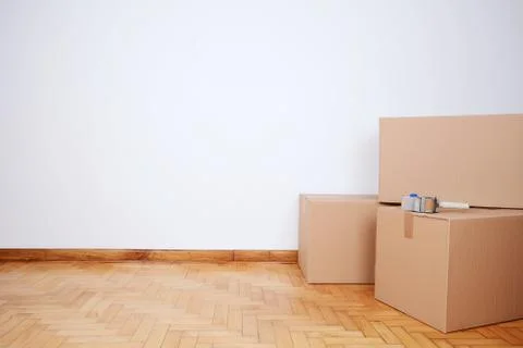 Stack of cardboard boxes in the empty room Stock Photos