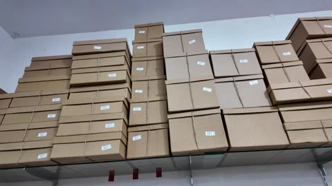 Stack of cardboard boxes on a hanging rack in a packaging shop Vídeos de archivo 291678811