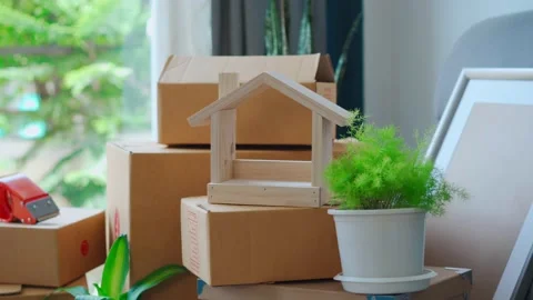 Stack of cardboard boxes in living room at new house on moving day Видео 138413139