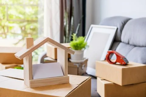Stack of cardboard boxes in living room at new house on moving day Fotos Stock