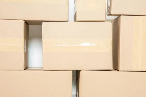 Stack of cardboard boxes for moving, Empty room with a white wall and cardboa 스톡 사진