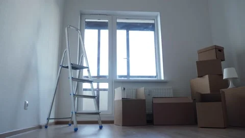 Stack of cardboard boxes for moving in interior apartment, movement or real Stock Footage 131094064