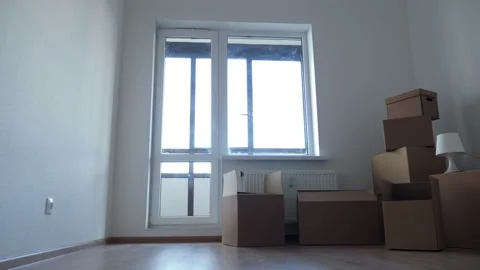 Stack of cardboard boxes for moving in interior apartment, movement or real Stock Footage 131094320