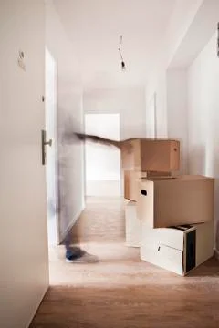 Stack of cardboard boxes in new house Stock Photos