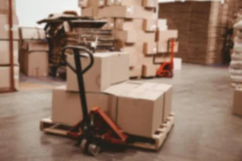 Stack of cardboard boxes on pulling hand cart Stock Photos