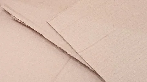 Stack of cardboard boxes with a white background. The boxes are cut in half a Stock Photos