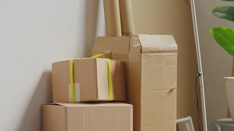 Stack of cardboard delivery boxes and moving supplies in modern apartment l.. Stock Footage 337760822