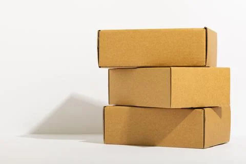Stack of cardboard gift boxes with copy space over white background Stock Photos