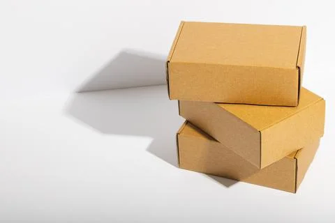 Stack of cardboard gift boxes with copy space over white background Stock Photos