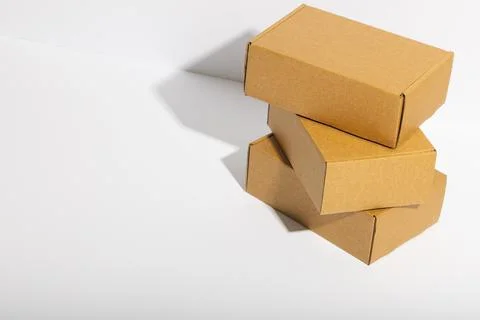 Stack of cardboard gift boxes with copy space over white background Stock Photos
