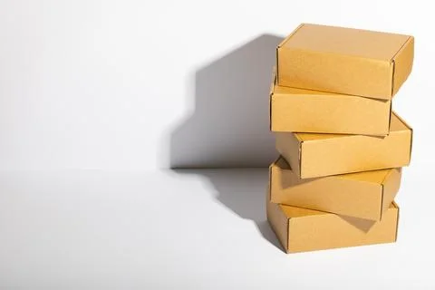 Stack of cardboard gift boxes with copy space over white background Stock Photos
