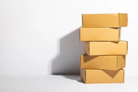 Stack of cardboard gift boxes with copy space over white background Stock Photos