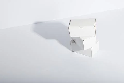 Stack of cardboard gift boxes with copy space over white background Stock Photos
