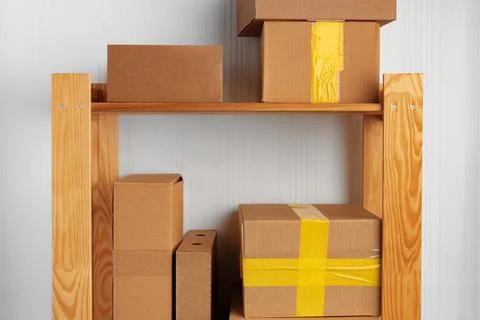 Stack of cardboard package boxes on wooden rack Stock Photos