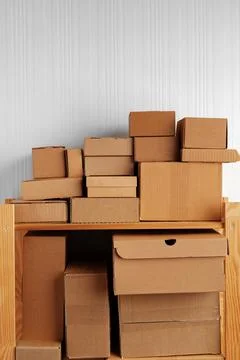 Stack of cardboard package boxes on wooden rack Stock Photos