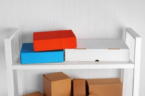 Stack of cardboard package boxes on wooden rack Stock Photos