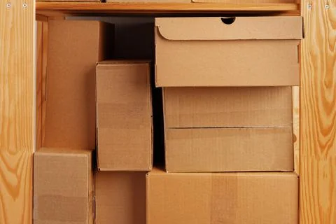 Stack of cardboard package boxes on wooden rack Stock Photos