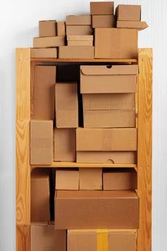 Stack of cardboard package boxes on wooden rack Stock Photos