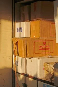 Stack of cardboard packing boxes of dvd covers Stock Photos
