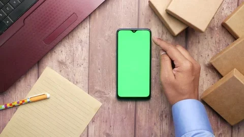 Stack of cardboard parcels , smart phone and laptop on table 스톡 동영상 172357798