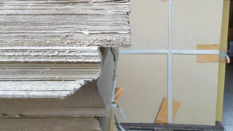 Stack of Cardboard Sheets in a Warehouse Storage Area. Stock Photos