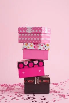 Stack of cardboard square gift boxes on a pink background Stock Photos