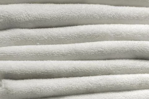 A stack of carelessly lying white towels, texture background. home cleanliness Stock Photos