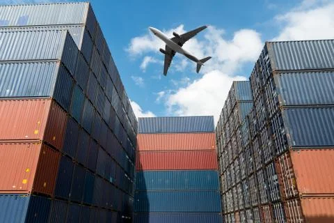 Stack of cargo containers with cargo airplane at import and export area at po Stock Photos