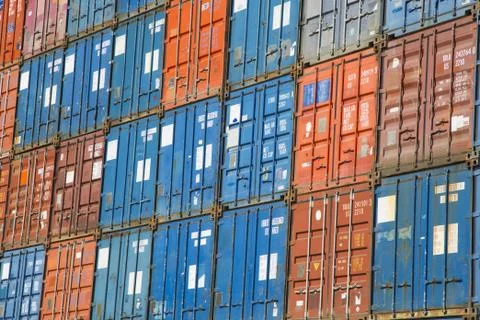 A stack of cargo containers, commercial freight containers, packed together a Foto stock