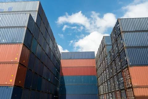 Stack of cargo containers at import and export area at port. Stock Photos